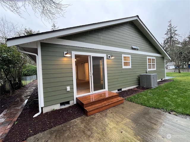 rear view of house featuring a yard and central AC unit