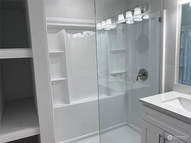 bathroom featuring vanity and a shower