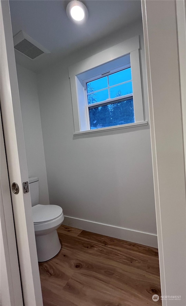 bathroom featuring toilet and hardwood / wood-style flooring