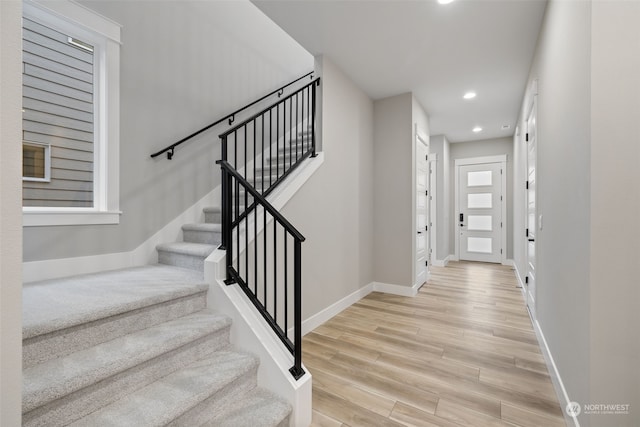 staircase with hardwood / wood-style flooring