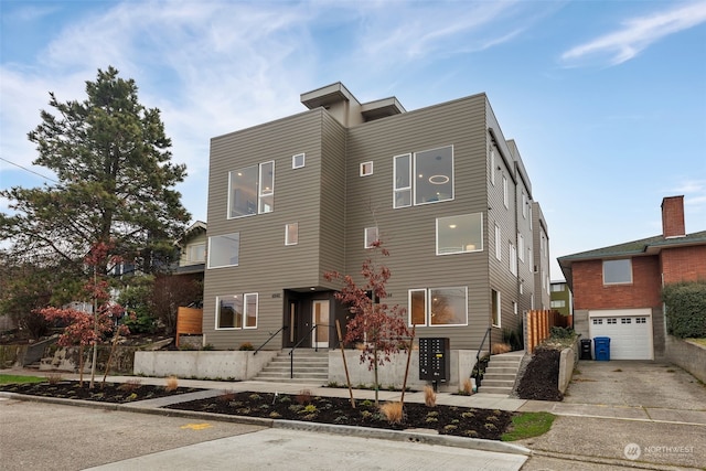 contemporary home featuring concrete driveway