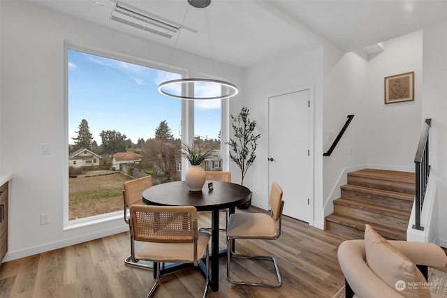 dining space featuring wood-type flooring