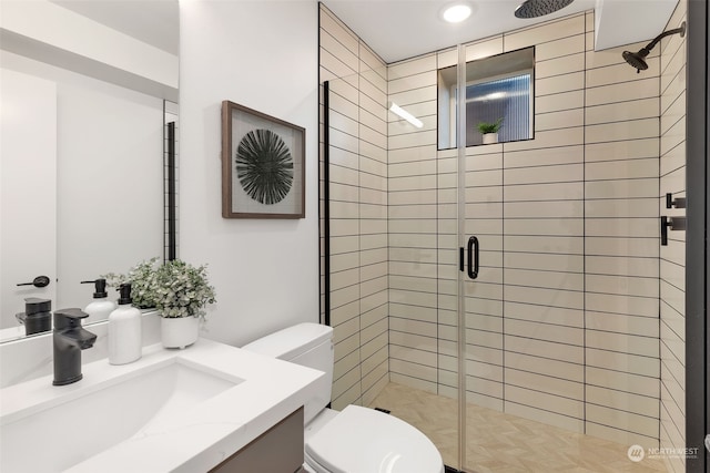 bathroom featuring vanity, walk in shower, and toilet