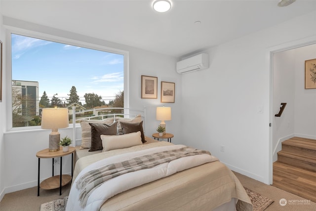 bedroom featuring a wall mounted air conditioner and carpet