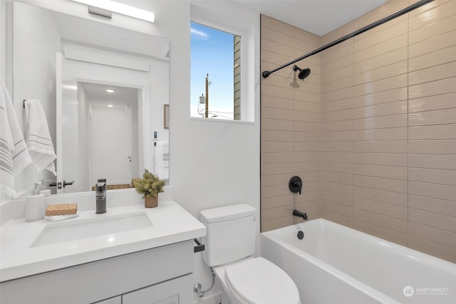 full bathroom with toilet, vanity, and tiled shower / bath