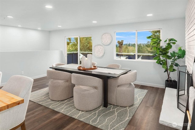 dining space with dark hardwood / wood-style floors and a healthy amount of sunlight