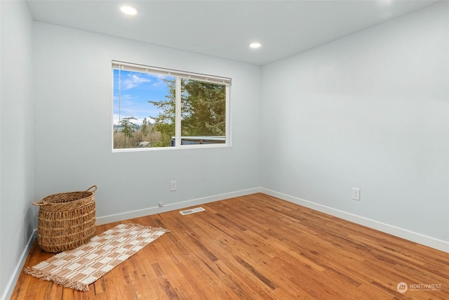 spare room with hardwood / wood-style flooring