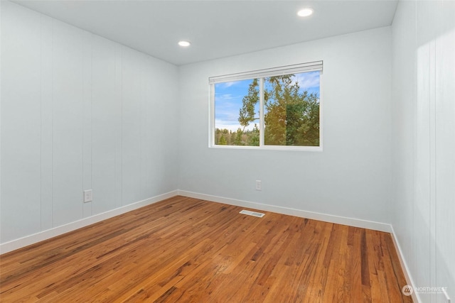 empty room featuring wood-type flooring