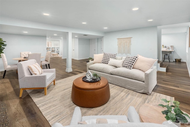 living room with hardwood / wood-style flooring and ornate columns