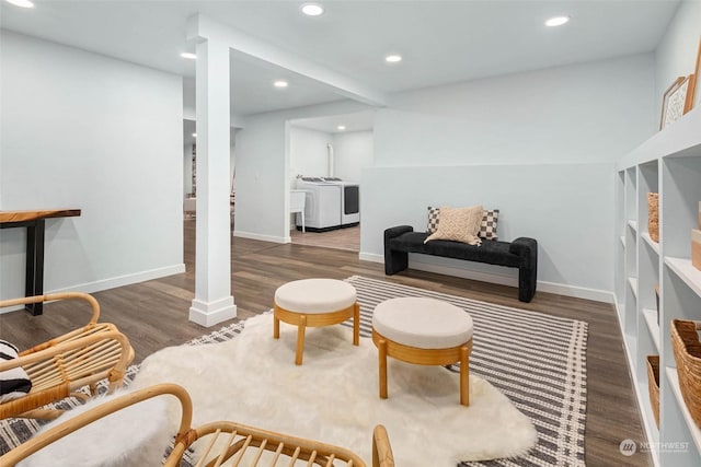 living room with washer / dryer and dark hardwood / wood-style flooring