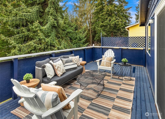 wooden terrace with an outdoor hangout area