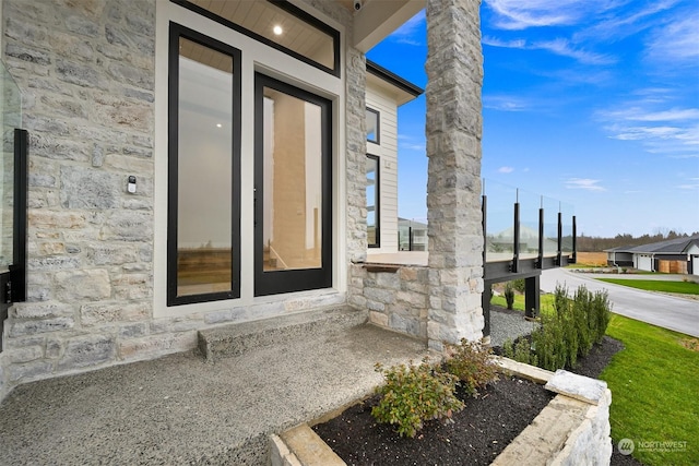 doorway to property featuring stone siding