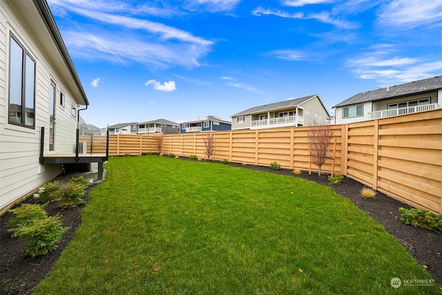 view of yard featuring a residential view and a fenced backyard