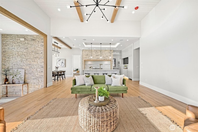 living room featuring light wood-style flooring, recessed lighting, and beamed ceiling