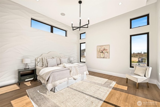 bedroom featuring recessed lighting, a chandelier, baseboards, and wood finished floors