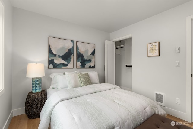 bedroom with a closet and wood-type flooring