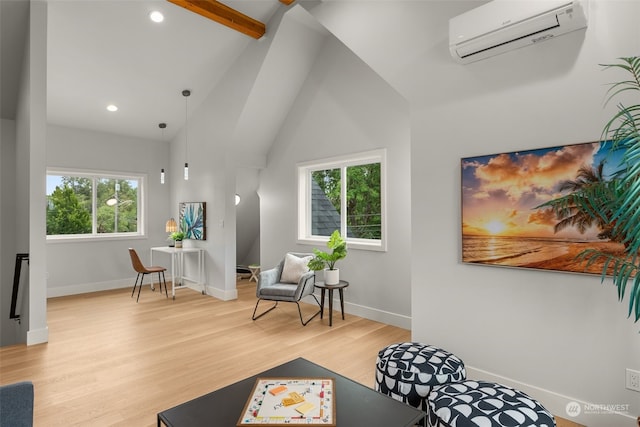 sitting room featuring light hardwood / wood-style floors, a wall mounted air conditioner, high vaulted ceiling, and beamed ceiling