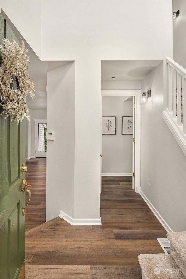 hall with dark wood-type flooring