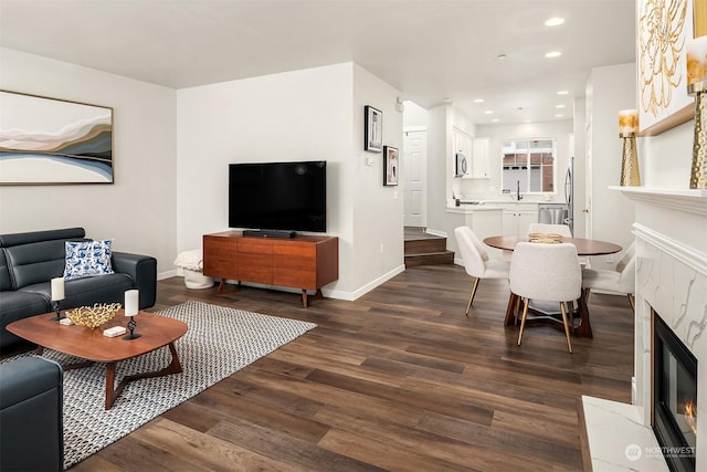 living room with dark hardwood / wood-style flooring and sink