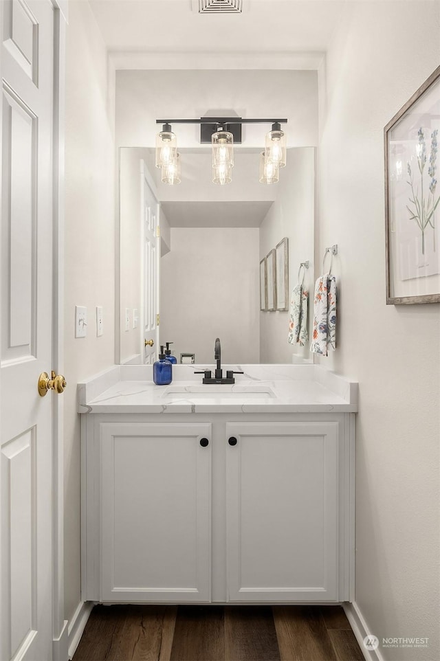 bathroom with vanity and hardwood / wood-style flooring