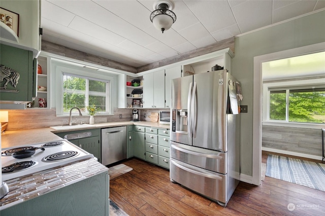 kitchen with dark hardwood / wood-style floors, stainless steel appliances, backsplash, plenty of natural light, and sink