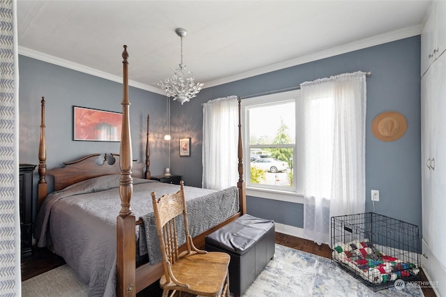 bedroom featuring ornamental molding, hardwood / wood-style flooring, and a notable chandelier