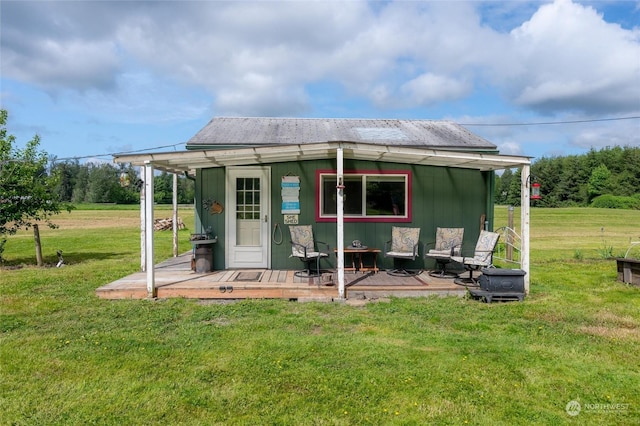 back of house with an outbuilding and a yard