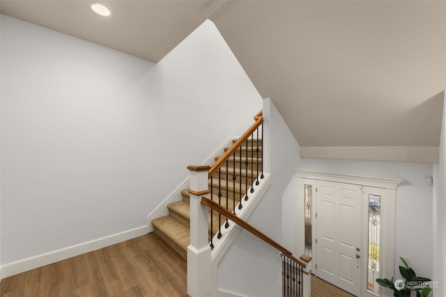 stairs featuring hardwood / wood-style floors