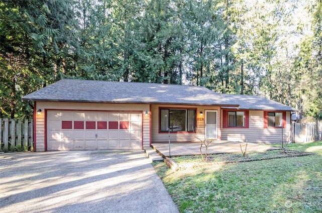 ranch-style house featuring a garage and a front yard