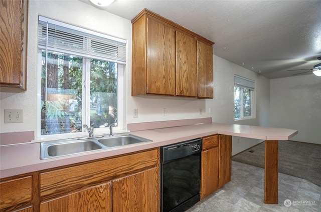 kitchen featuring sink, ceiling fan, black dishwasher, a textured ceiling, and kitchen peninsula