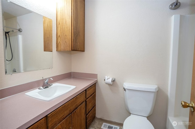 bathroom featuring vanity and toilet