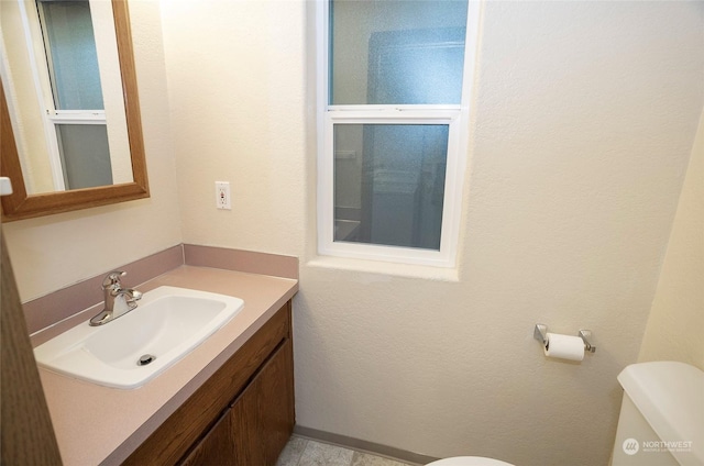 bathroom with vanity and toilet