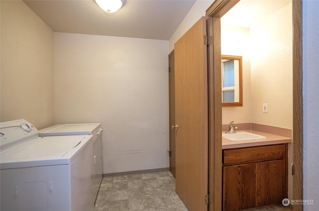 washroom with independent washer and dryer and sink