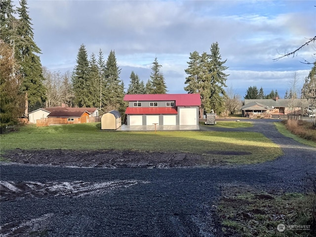 exterior space with an outbuilding, a front lawn, and a garage