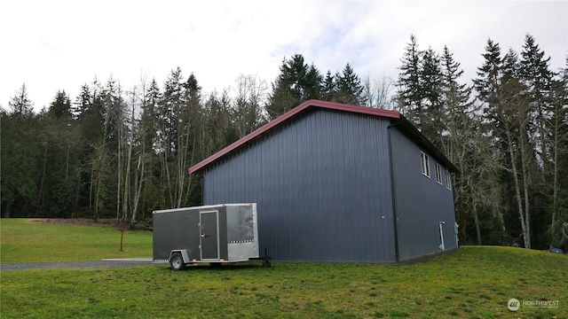 view of outbuilding with a lawn