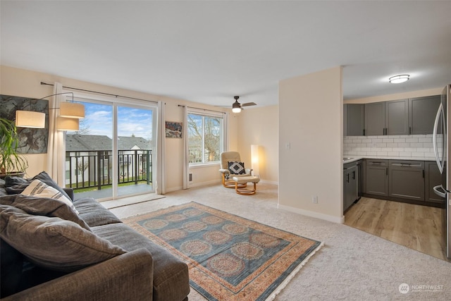 living room with light carpet and ceiling fan