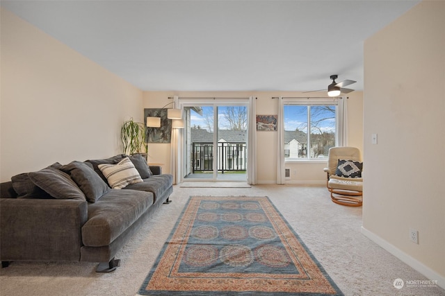 carpeted living room with ceiling fan