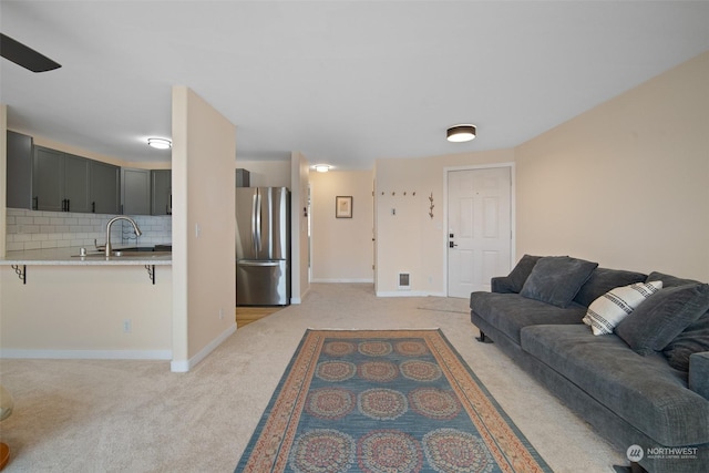 carpeted living room featuring sink