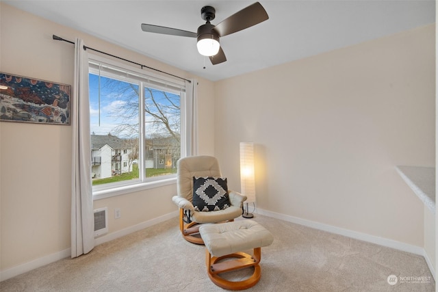 living area featuring ceiling fan and light carpet