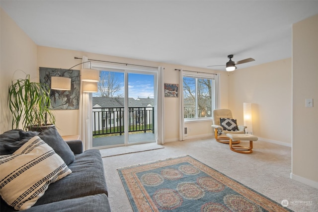 living room featuring ceiling fan and carpet