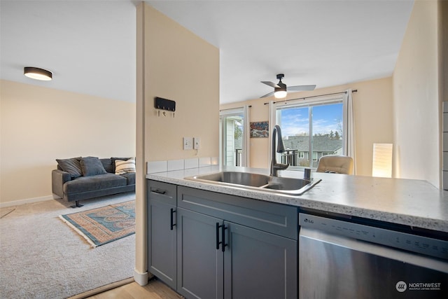 kitchen featuring sink, ceiling fan, gray cabinets, dishwasher, and light colored carpet