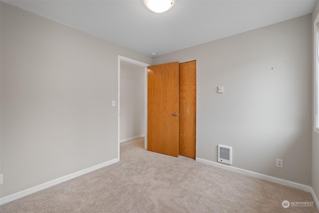 unfurnished room with light carpet