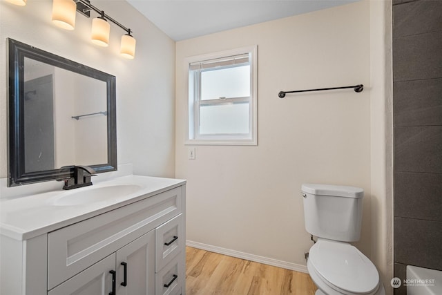 bathroom featuring vanity, hardwood / wood-style floors, and toilet