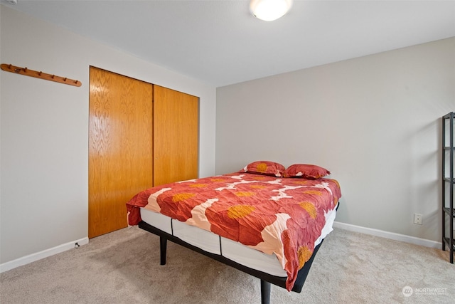 bedroom with light carpet and a closet