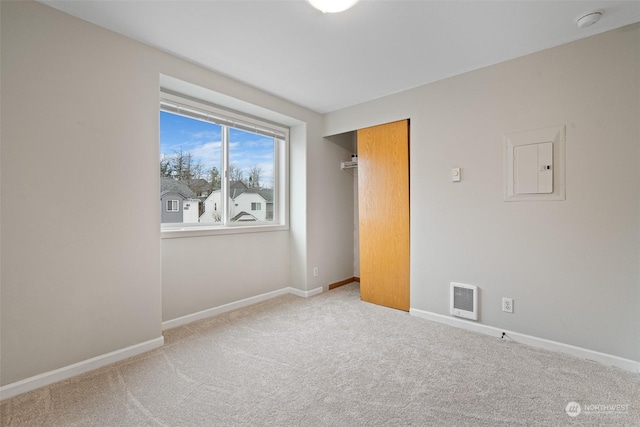 spare room with light colored carpet and electric panel