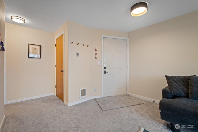 view of carpeted foyer entrance