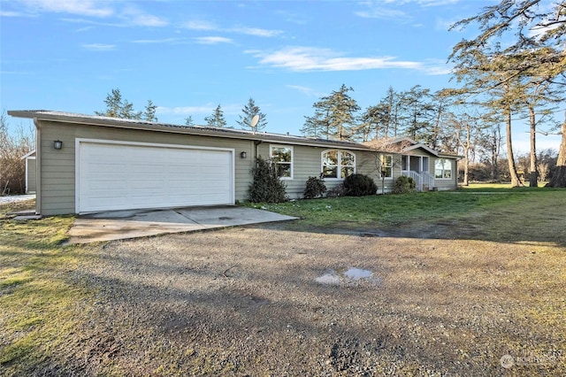 ranch-style home with a garage and a front lawn