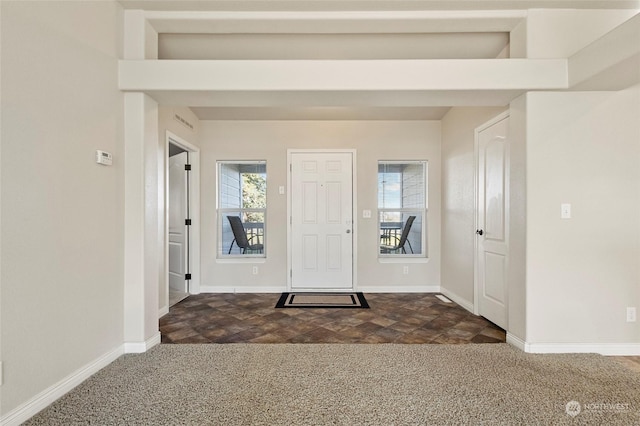 foyer with dark colored carpet