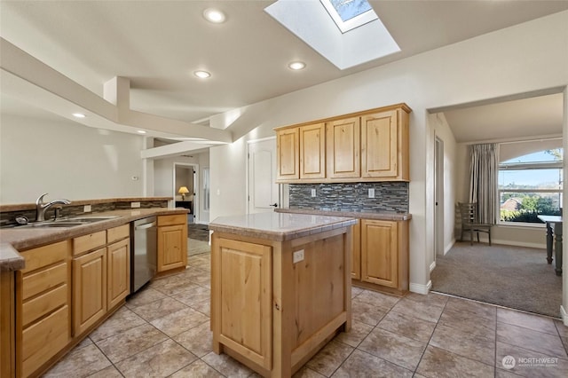 kitchen featuring a kitchen island, sink, backsplash, stainless steel dishwasher, and light brown cabinets