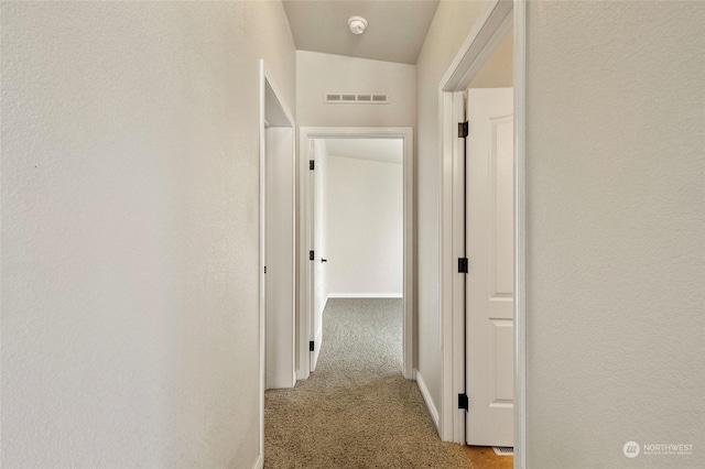 hallway with light colored carpet